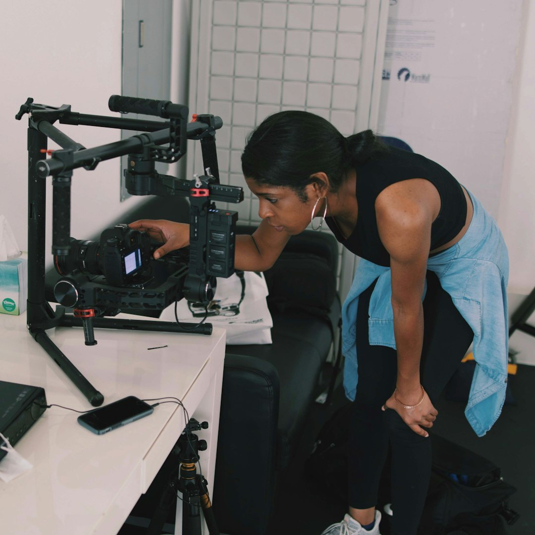 Trainee operating a camera under instructor supervision