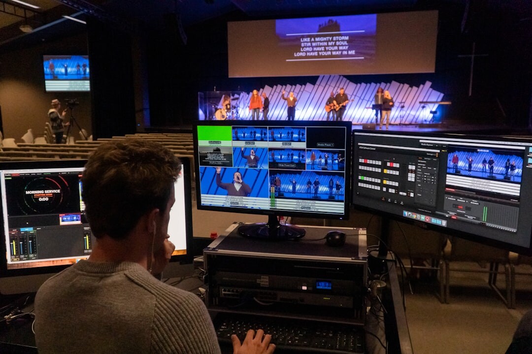Broadcast control room with multiple video monitors and switcher panel