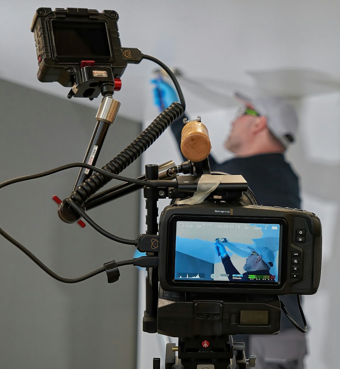 Broadcast director giving cues in front of monitors during a live show