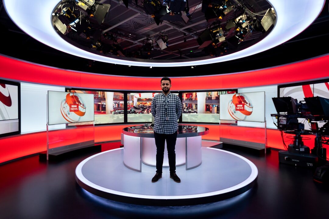 Empty news anchor desk with microphones in a TV studio